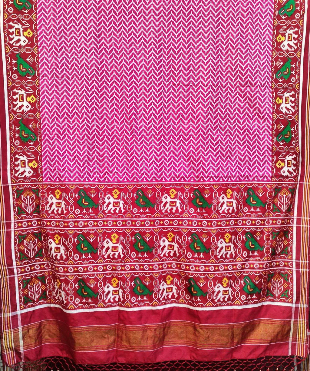 Model wearing a dark pink Patan Patola pure mulberry silk saree featuring a body with lehriya design and contrasting red borders and pallu with elephant motifs.