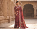 An exquisite maroon Patan Patola double ikat pure mulberry silk saree featuring intricate traditional geometric motifs, rich contrasting borders, and a masterpiece pallu dyed using natural vegetable colors.