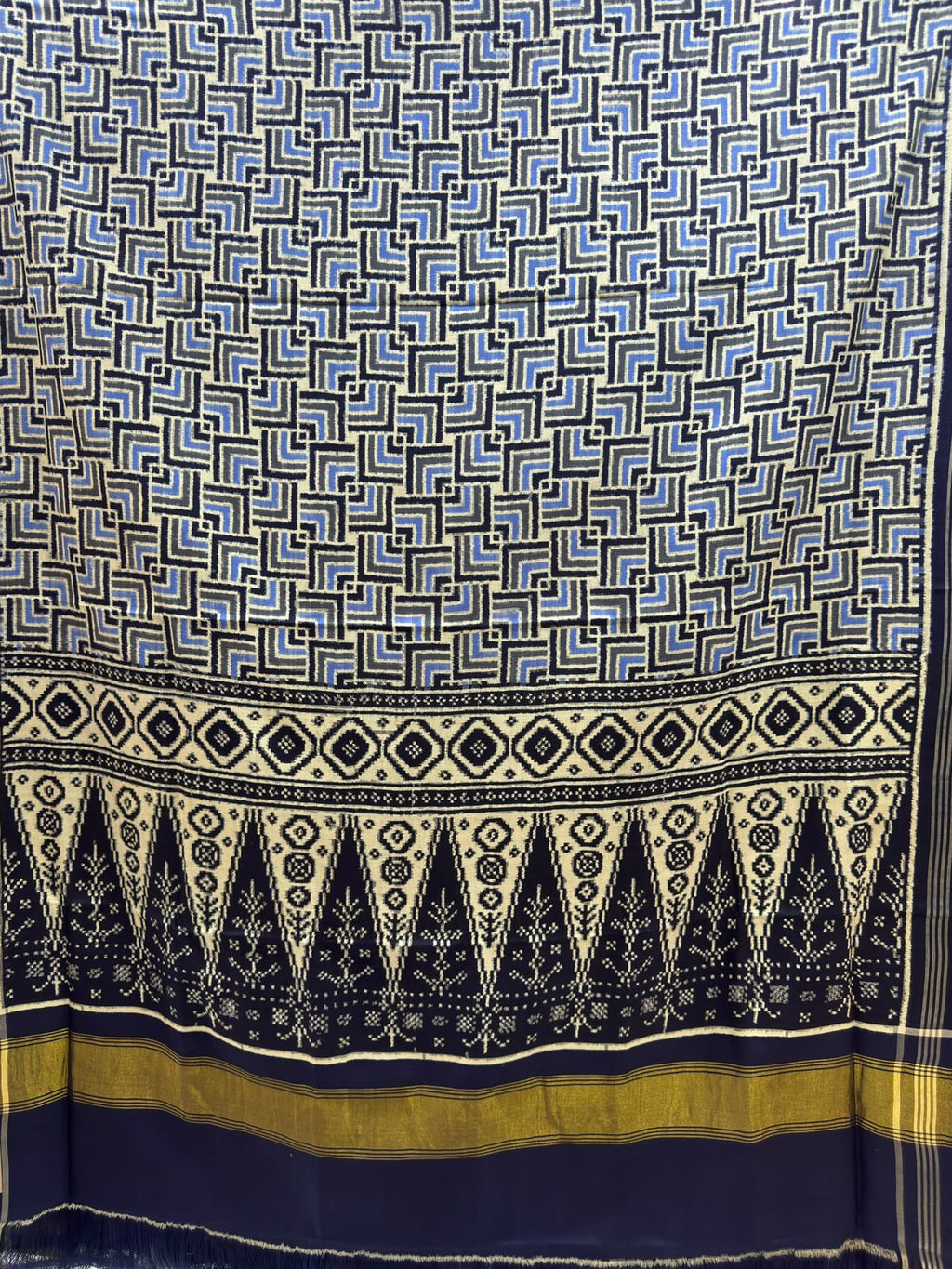 Black and blue Patan Patola pure mulberry silk saree featuring a geometric labyrinth pattern with a traditional black and cream patterned pallu.