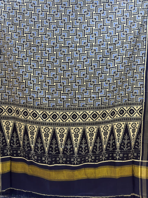 Black and blue Patan Patola pure mulberry silk saree featuring a geometric labyrinth pattern with a traditional black and cream patterned pallu.