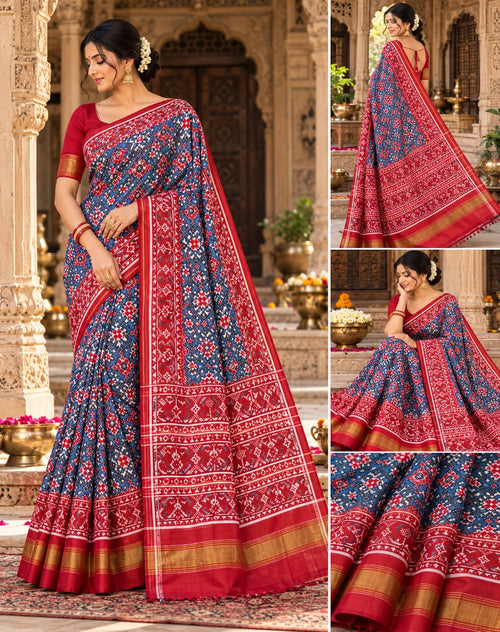 A magnificent blue Patan Patola double ikat pure mulberry silk saree featuring intricate red and white geometric motifs, a striking rich red pallu with traditional tree designs, and contrasting borders.