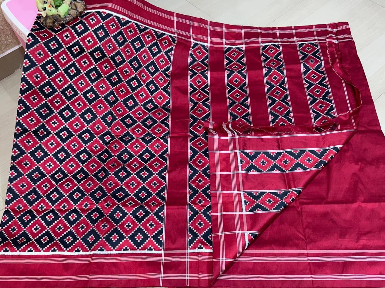 Red Pochampally Handloom Double Ikat Patola Silk Saree, showcasing its rich geometric pattern and premium texture.