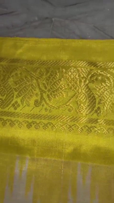 Cream Pochampally Handloom Pure Ikkat Silk Saree featuring yellow and pink Ganga Yamuna temple design borders.