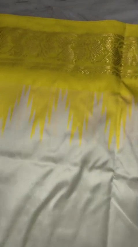 Cream Pochampally Handloom Pure Ikkat Silk Saree featuring yellow and pink Ganga Yamuna temple design borders.