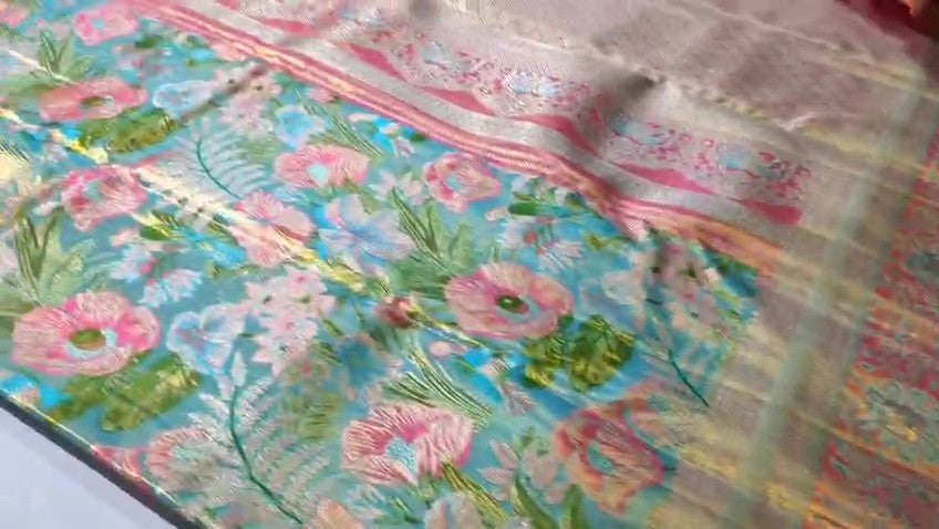 Turquoise Kanchipuram handloom tissue brocade Meenakari silk saree with intricate floral motifs and a pink contrast border.