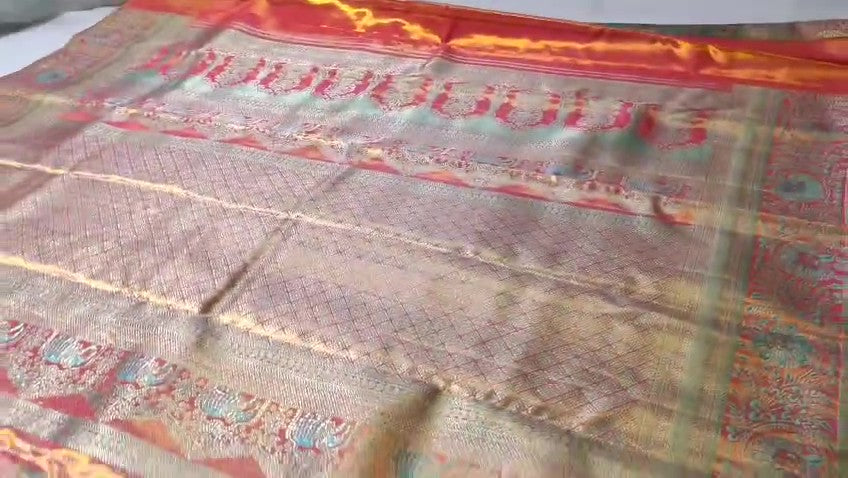 Turquoise Kanchipuram handloom tissue brocade Meenakari silk saree with intricate floral motifs and a pink contrast border.