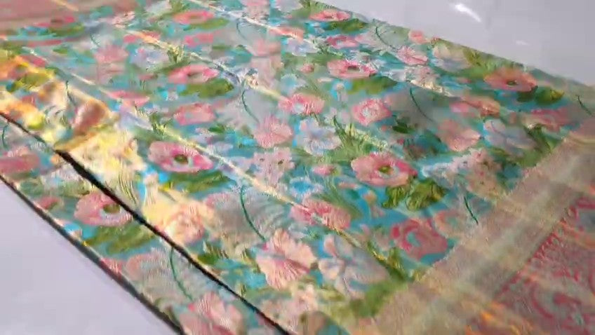 Turquoise Kanchipuram handloom tissue brocade Meenakari silk saree with intricate floral motifs and a pink contrast border.