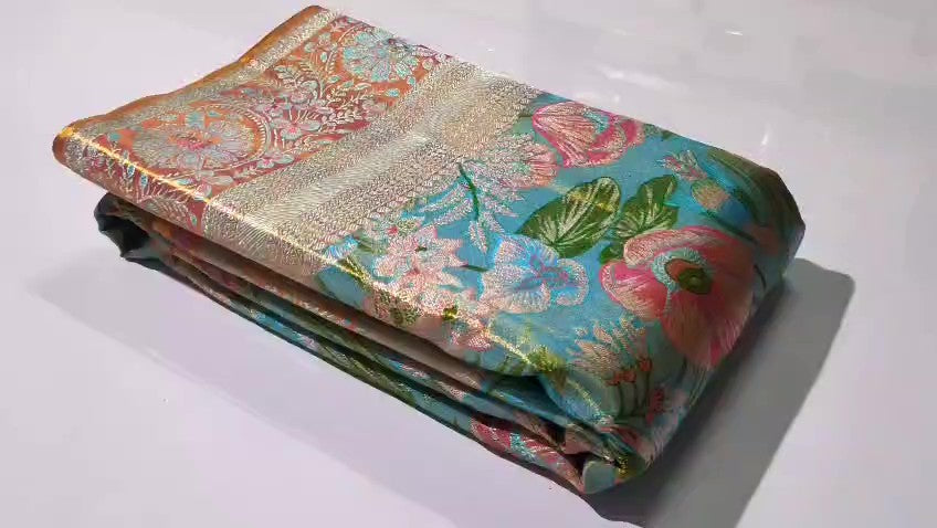 Turquoise Kanchipuram handloom tissue brocade Meenakari silk saree with intricate floral motifs and a pink contrast border.