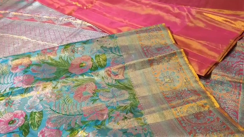 Turquoise Kanchipuram handloom tissue brocade Meenakari silk saree with intricate floral motifs and a pink contrast border.
