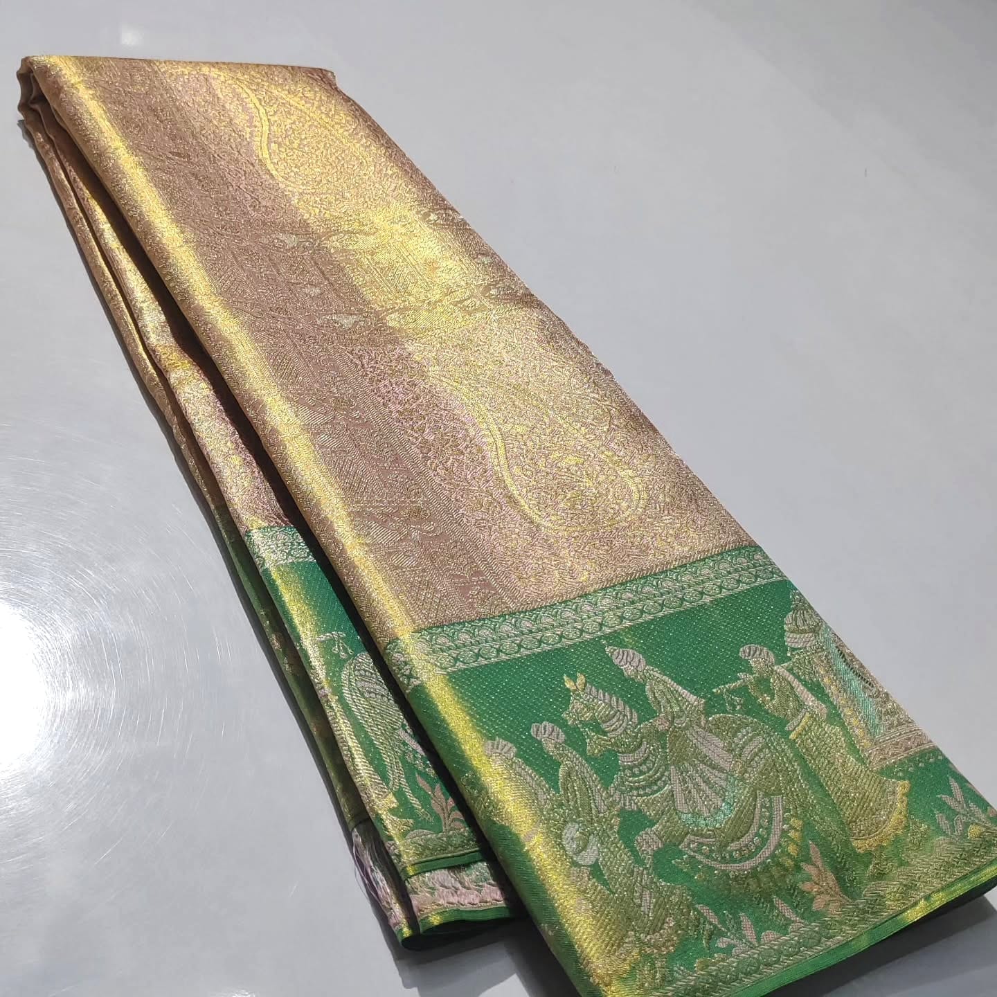 Baby Pink Kanchipuram handloom silk saree featuring intricate gold tissue brocade and a traditional Kalyana Pallakku motif border.