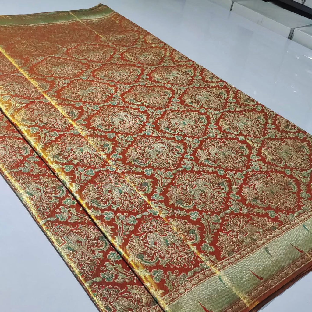 Exquisite coral Kanchipuram handloom tissue brocade Meenakari bridal saree with traditional Paithani borders.