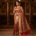 Exquisite coral Kanchipuram handloom tissue brocade Meenakari bridal saree with traditional Paithani borders.