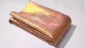 Dual-tone peach Kanchipuram handloom tissue brocade silk saree with intricate gold zari detailing, perfect for elegant wedding and festive looks.