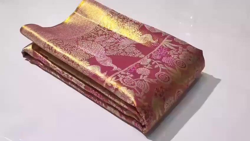 Dual-tone red Kanchipuram handloom tissue brocade silk saree, showcasing intricate gold zari floral and peacock patterns, suitable for weddings and grand events.