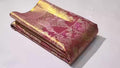 Dual-tone red Kanchipuram handloom tissue brocade silk saree, showcasing intricate gold zari floral and peacock patterns, suitable for weddings and grand events.