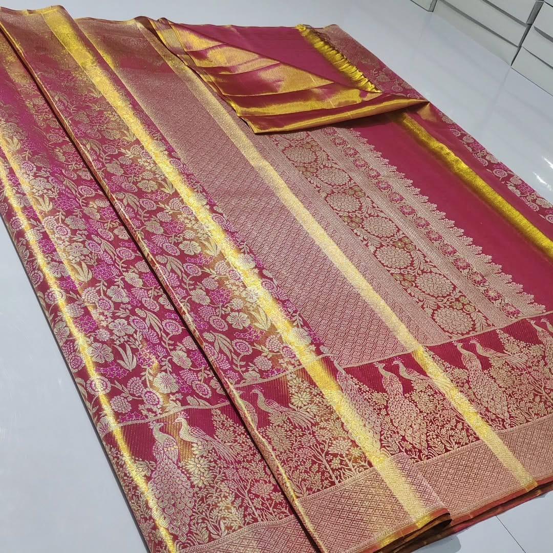 Dual-tone red Kanchipuram handloom tissue brocade silk saree, showcasing intricate gold zari floral and peacock patterns, suitable for weddings and grand events.