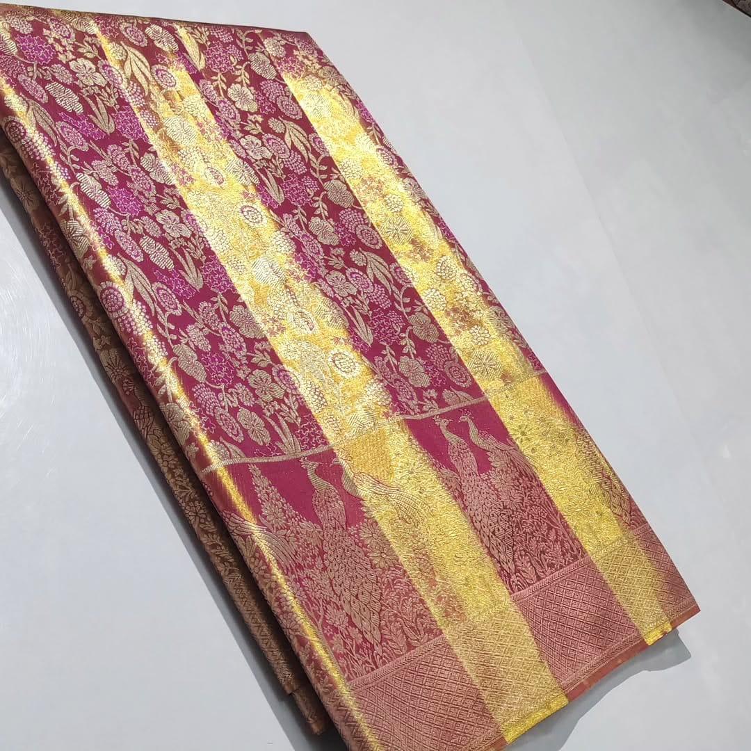 Dual-tone red Kanchipuram handloom tissue brocade silk saree, showcasing intricate gold zari floral and peacock patterns, suitable for weddings and grand events.