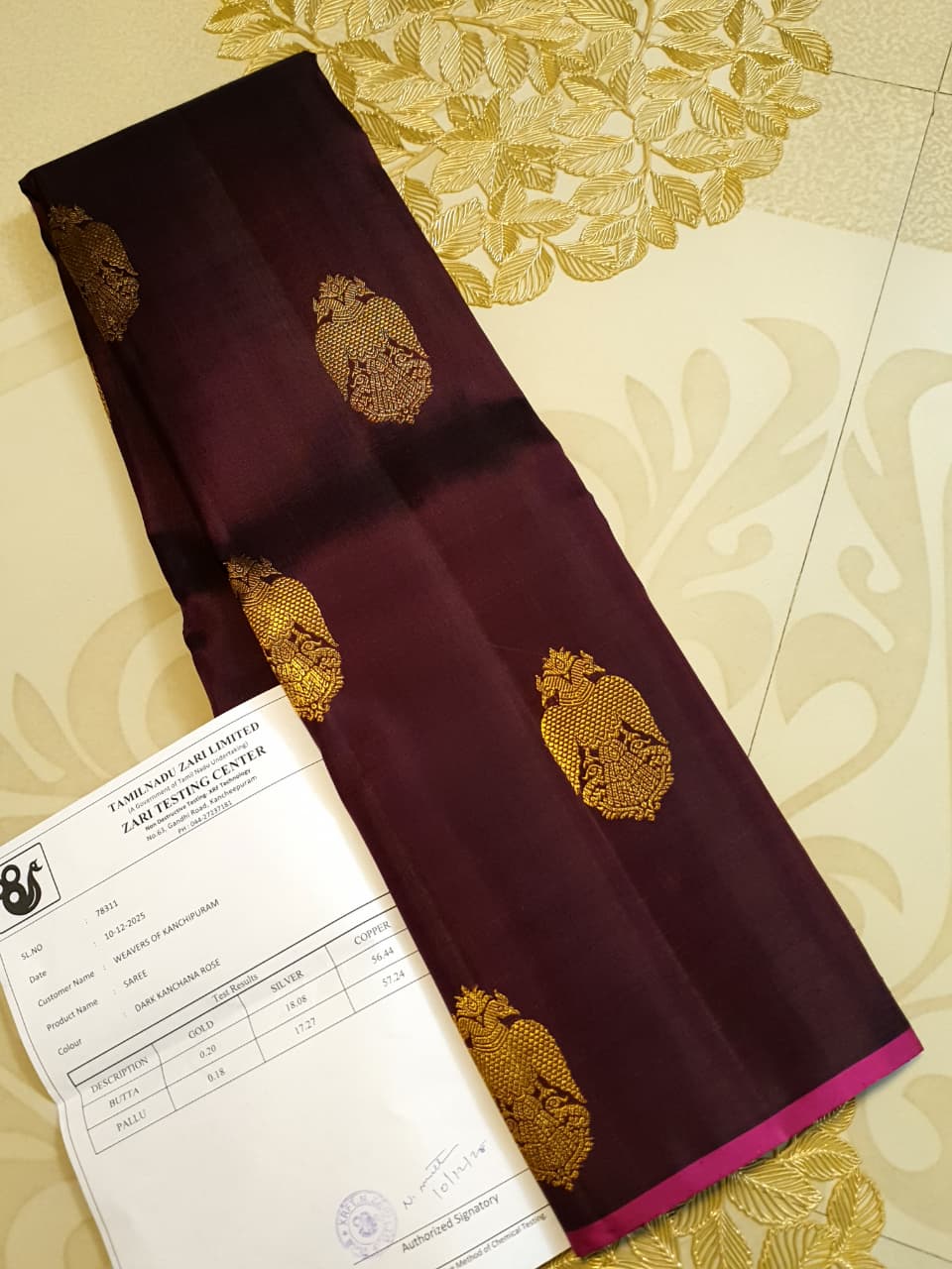 A certified magenta Kanchipuram handloom 3G pure gold borderless silk saree showcasing its rich color and lustrous weave.