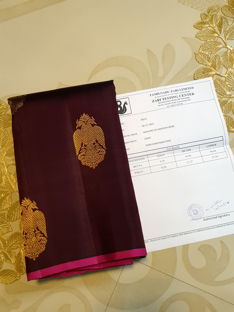 A certified magenta Kanchipuram handloom 3G pure gold borderless silk saree showcasing its rich color and lustrous weave.