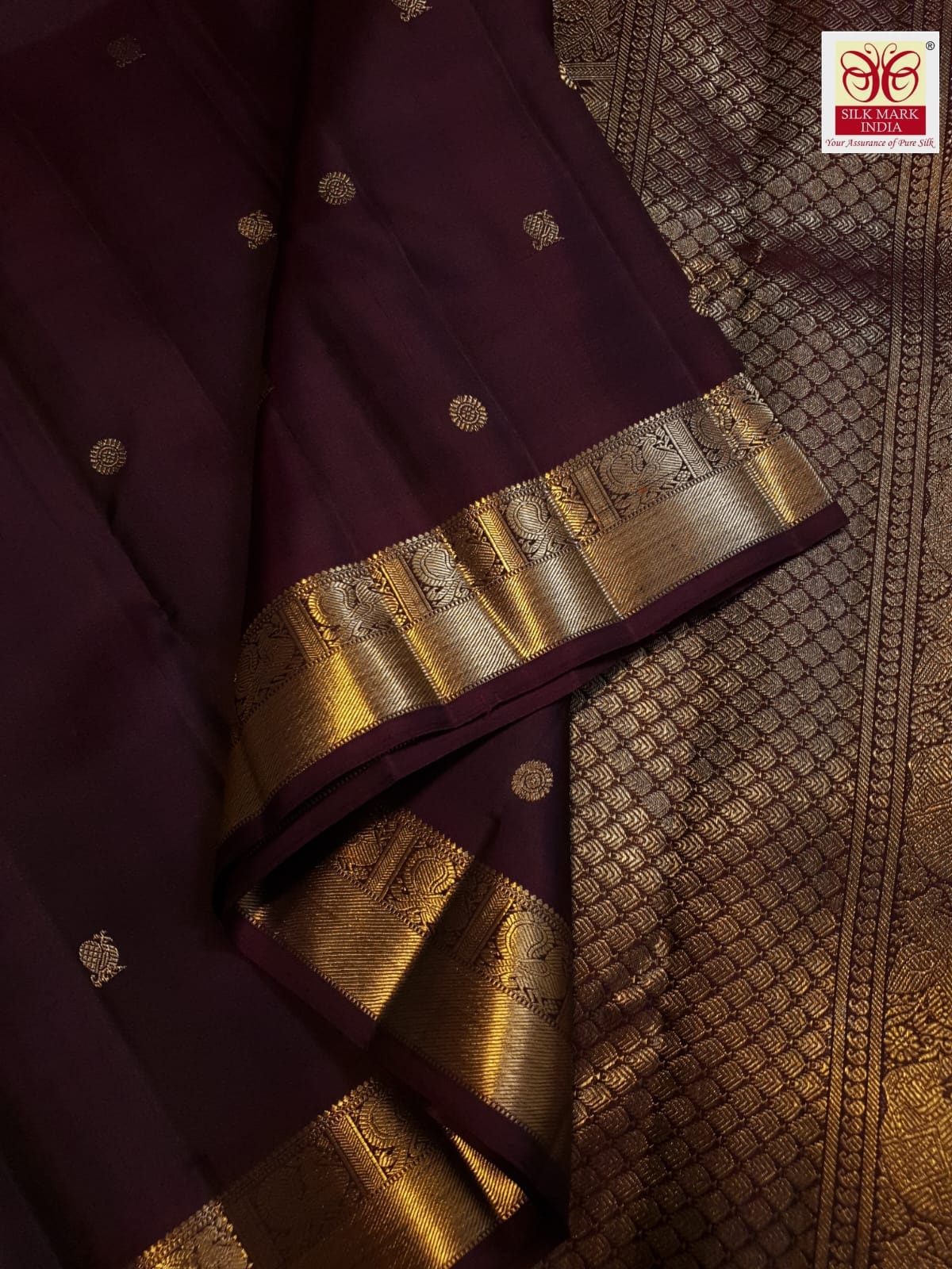A deep purple Kanchipuram handloom 3G gold pattu silk saree adorned with intricate gold buttas and a rich traditional pallu.