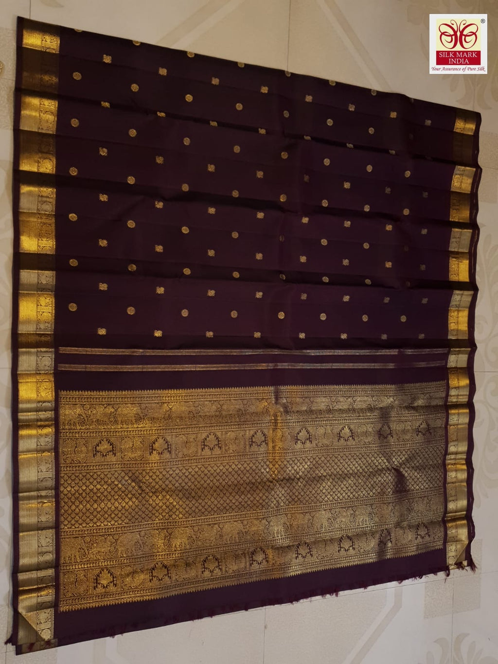 A deep purple Kanchipuram handloom 3G gold pattu silk saree adorned with intricate gold buttas and a rich traditional pallu.