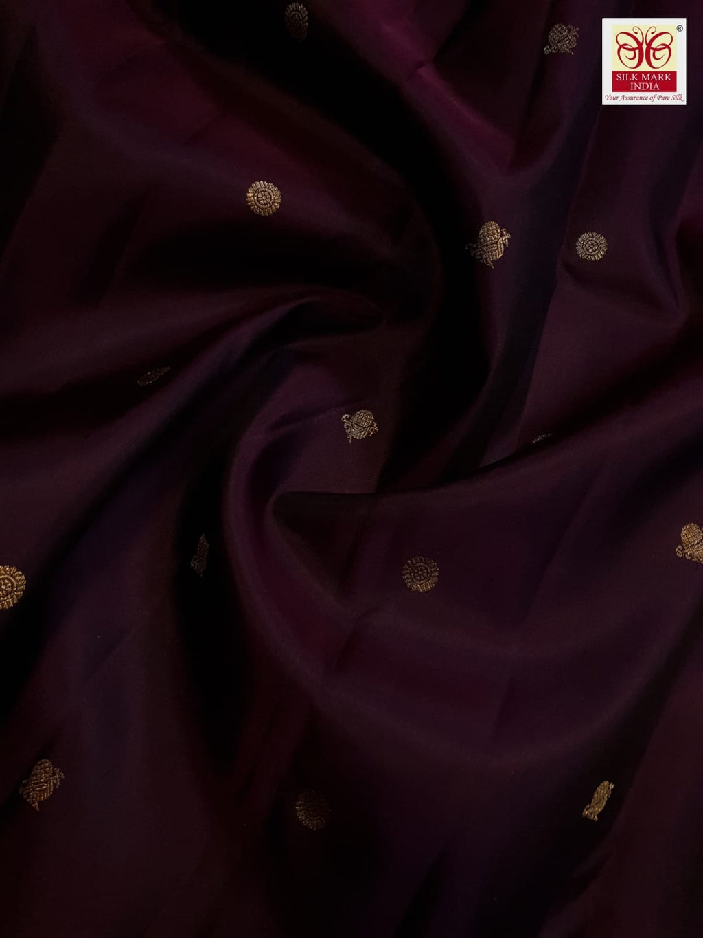 A deep purple Kanchipuram handloom 3G gold pattu silk saree adorned with intricate gold buttas and a rich traditional pallu.