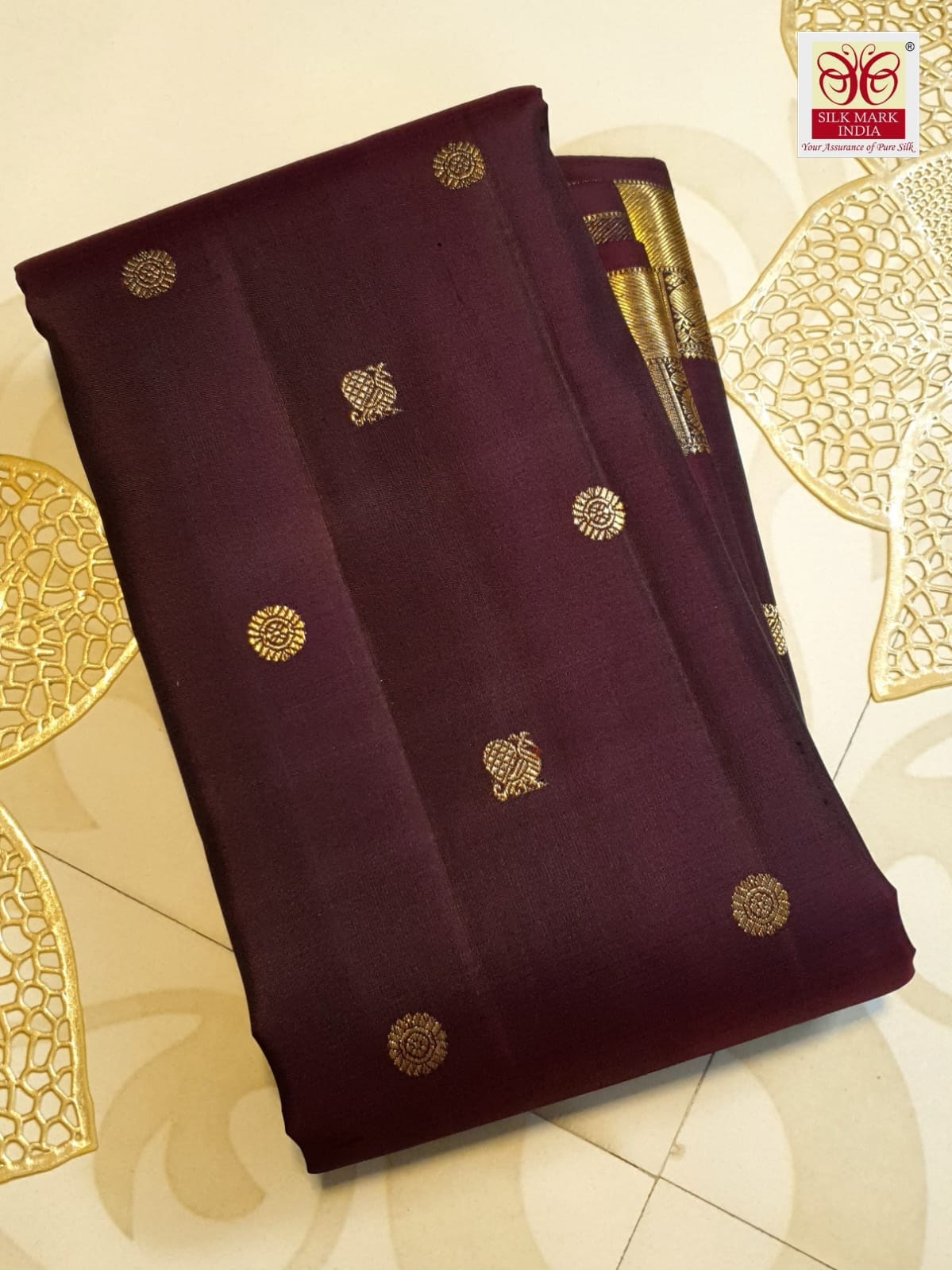 A deep purple Kanchipuram handloom 3G gold pattu silk saree adorned with intricate gold buttas and a rich traditional pallu.