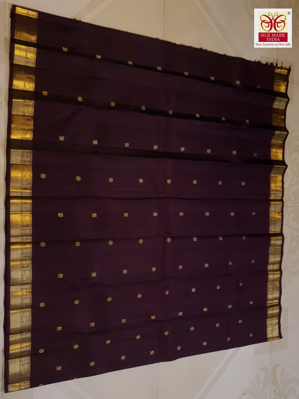 A deep purple Kanchipuram handloom 3G gold pattu silk saree adorned with intricate gold buttas and a rich traditional pallu.