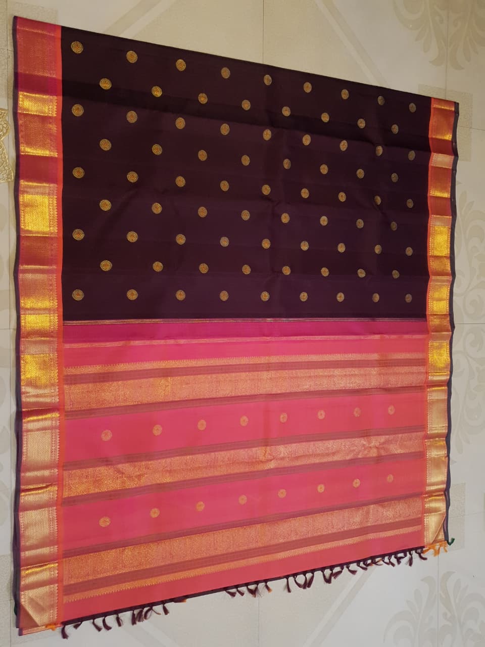 A rich brown Kanchipuram handloom 3G gold vintage korvai silk saree showcasing traditional contrasting borders and intricate motifs.