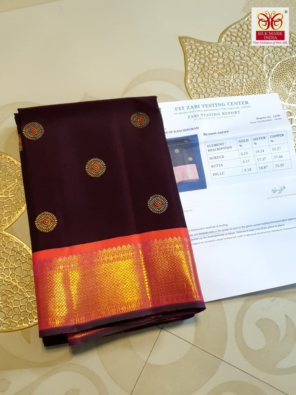 A rich brown Kanchipuram handloom 3G gold vintage korvai silk saree showcasing traditional contrasting borders and intricate motifs.