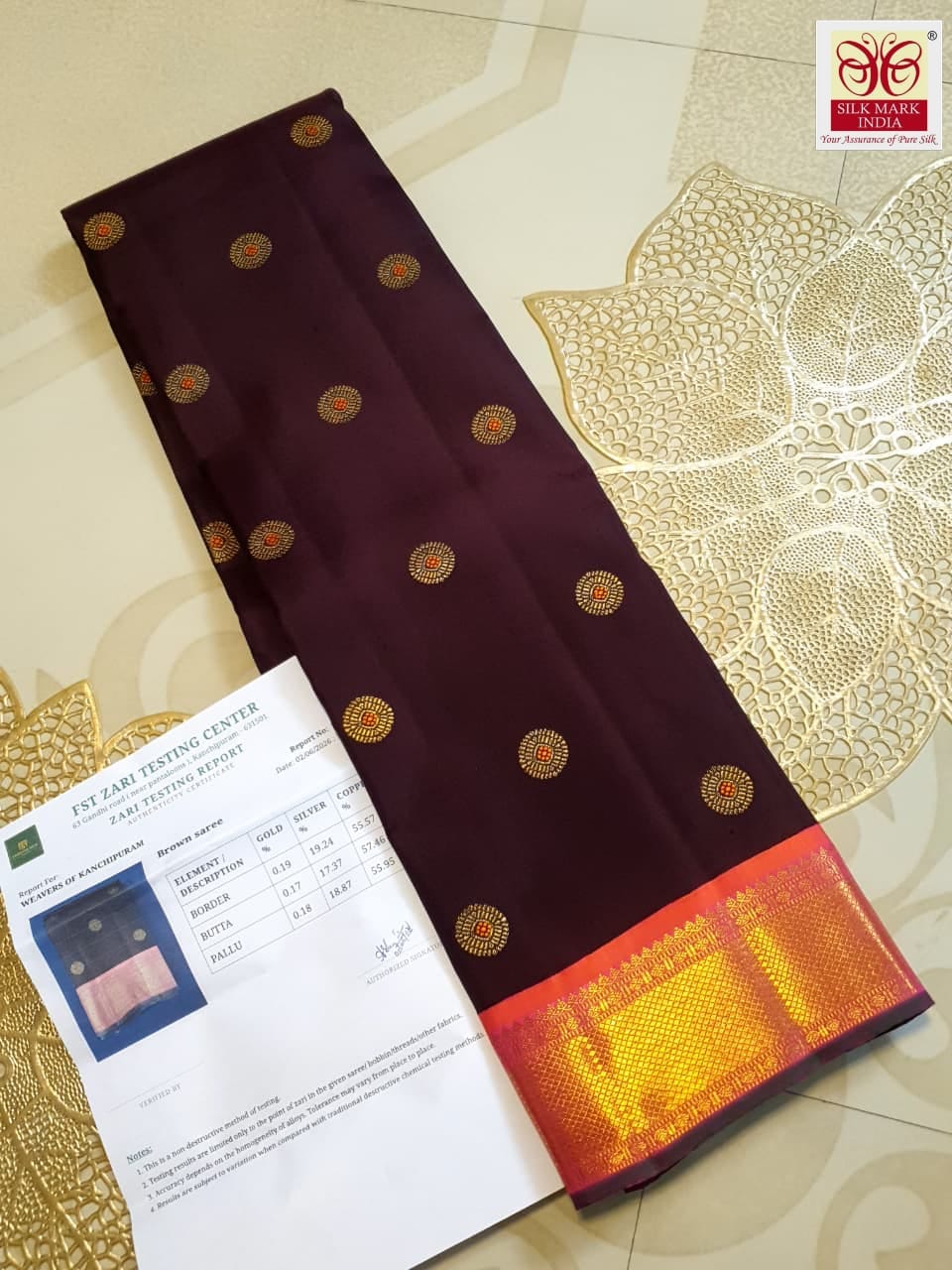 A rich brown Kanchipuram handloom 3G gold vintage korvai silk saree showcasing traditional contrasting borders and intricate motifs.