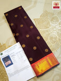 A rich brown Kanchipuram handloom 3G gold vintage korvai silk saree showcasing traditional contrasting borders and intricate motifs.