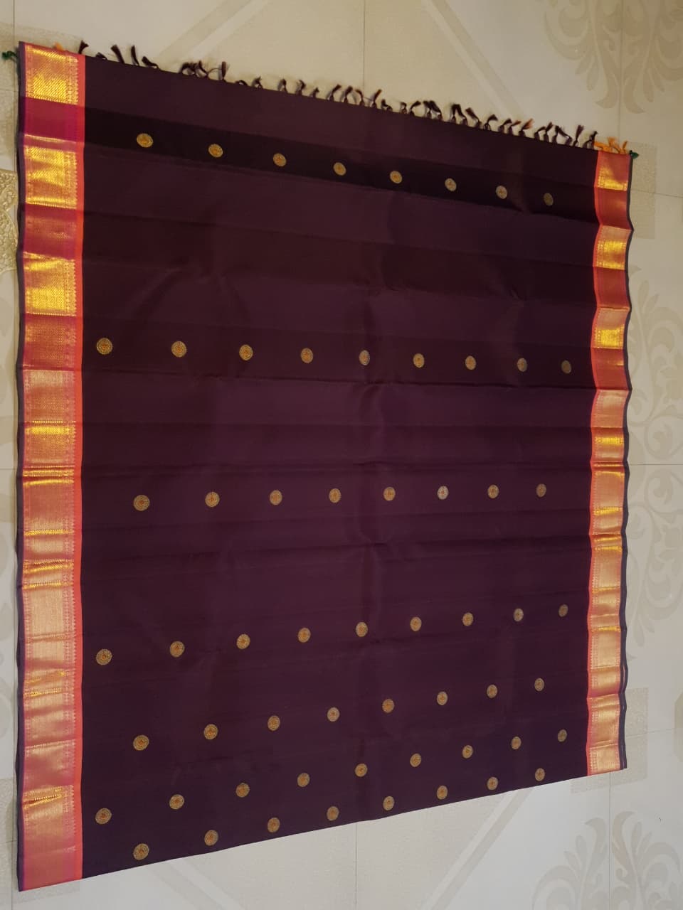 A rich brown Kanchipuram handloom 3G gold vintage korvai silk saree showcasing traditional contrasting borders and intricate motifs.