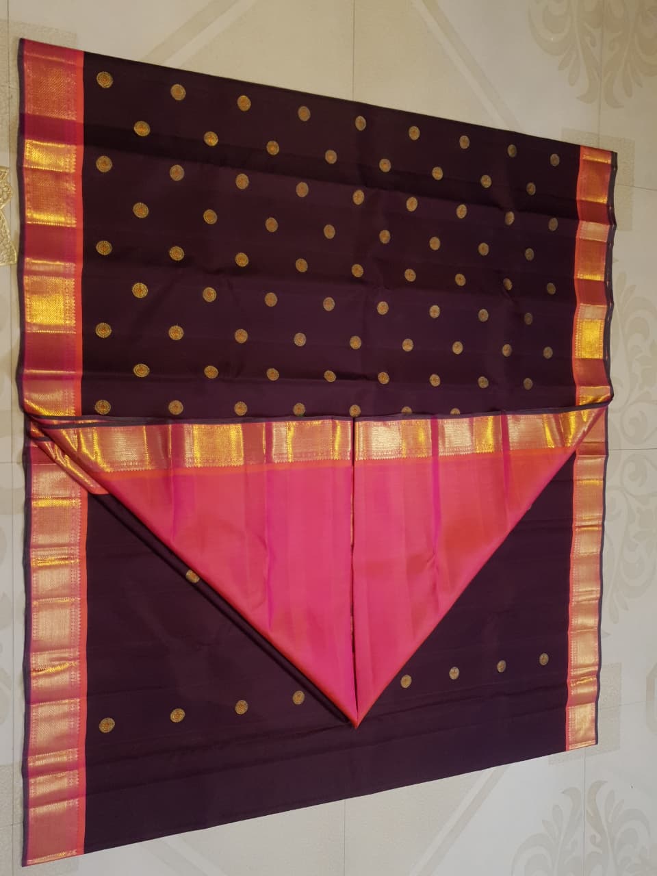 A rich brown Kanchipuram handloom 3G gold vintage korvai silk saree showcasing traditional contrasting borders and intricate motifs.