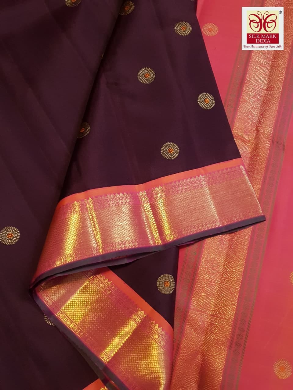 A rich brown Kanchipuram handloom 3G gold vintage korvai silk saree showcasing traditional contrasting borders and intricate motifs.