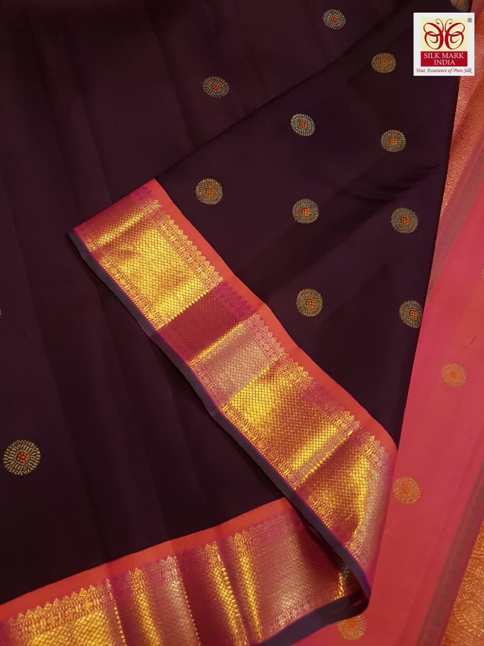 A rich brown Kanchipuram handloom 3G gold vintage korvai silk saree showcasing traditional contrasting borders and intricate motifs.