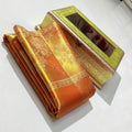 Orange Kanchipuram Handloom Tissue Silk Saree highlighting the intricate gold Meenakari brocade and signature tissue texture.