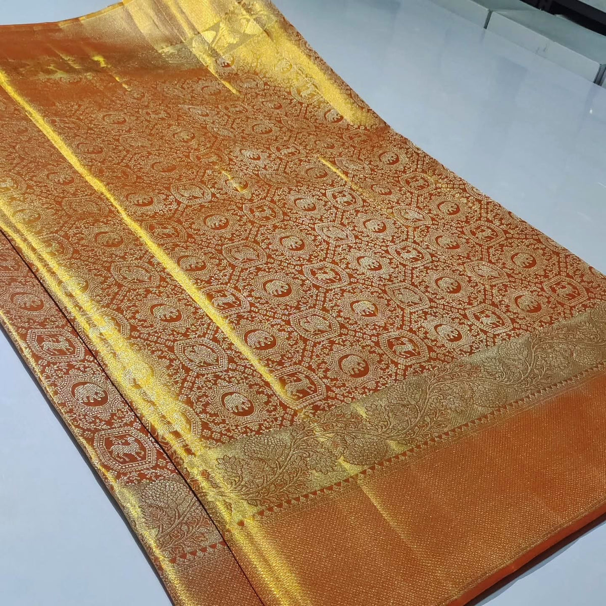 Elegant orange Kanchipuram handloom tissue brocade silk bridal saree with intricate meena detailing