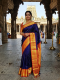 Deep Purple Kanchipuram Handloom Silk Saree with multicolored chakram motifs across the body and a wide red Korvai border featuring intricate gold zari.