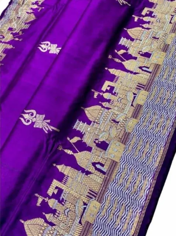 Royal purple Katan silk saree featuring gold zari Damru and Trishul motifs on the body and an intricate Kashi Ghat temple border.