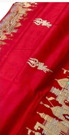 Exquisite Rustic Red Banarasi Katan Silk Saree featuring the legendary Kashi Ghat Meenakari design. Silk Mark Certified for 100% purity. A masterpiece of handloom storytelling.