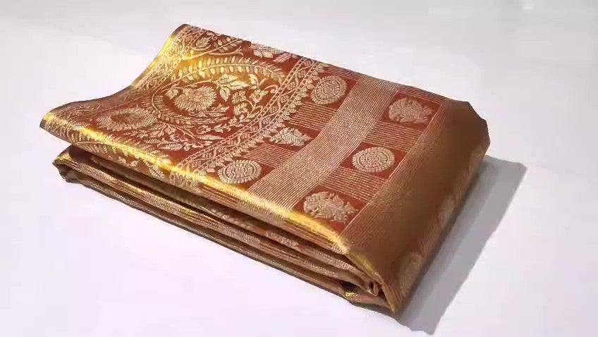 Copper Kanchipuram Handloom Tissue Brocade Silk Meenakari Saree displayed in a neat fold showcasing its rich gold zari and floral weave details.