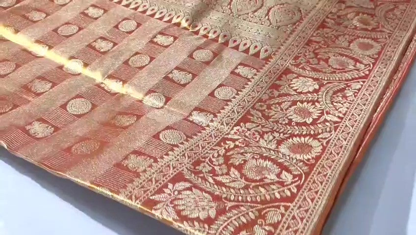 Copper Kanchipuram Handloom Tissue Brocade Silk Meenakari Saree displayed in a neat fold showcasing its rich gold zari and floral weave details.