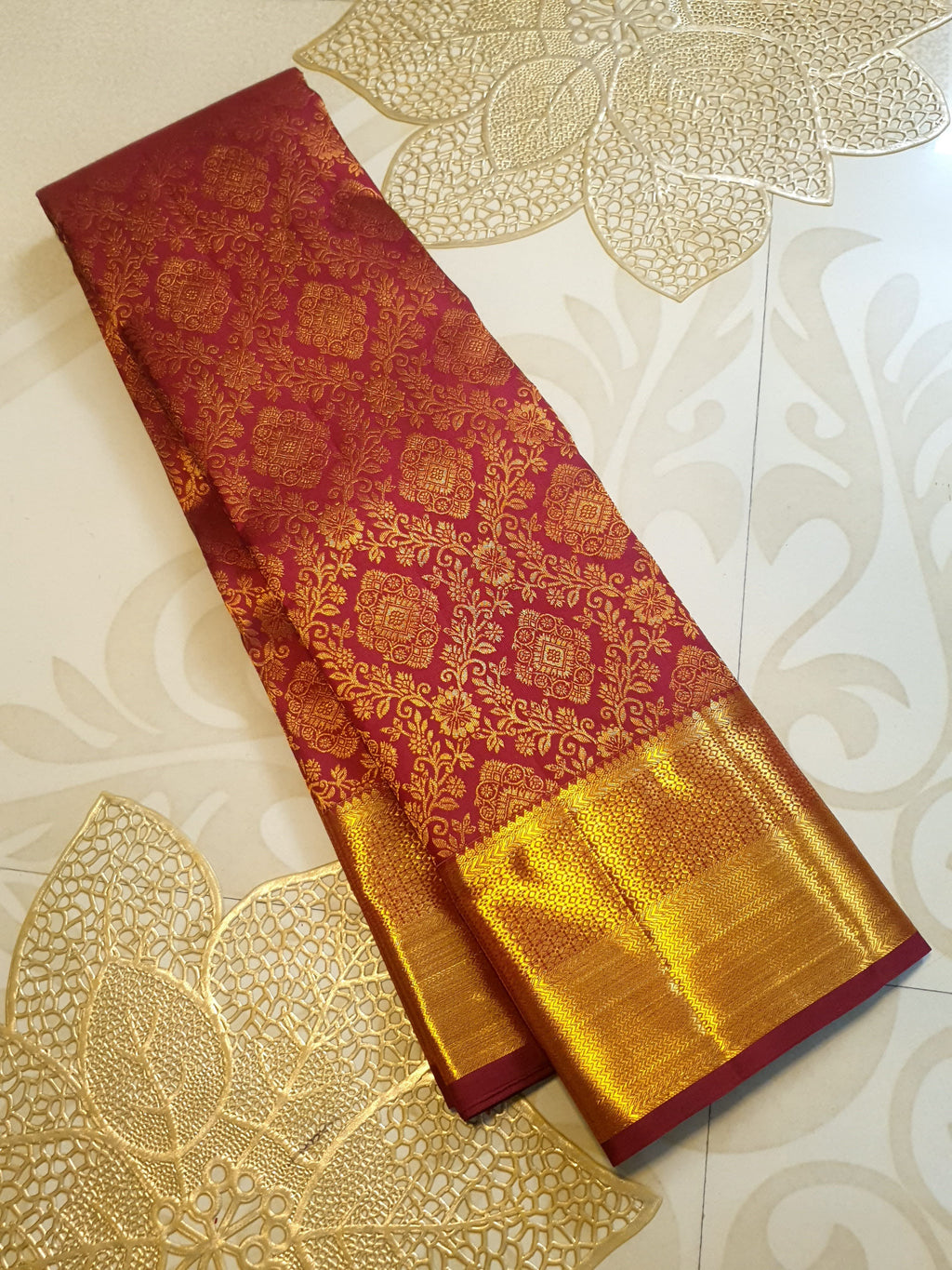 Red Kanchipuram handloom 2G gold pattu silk saree featuring intricate gold brocade weaving and a detailed Lord Murugan pallu.