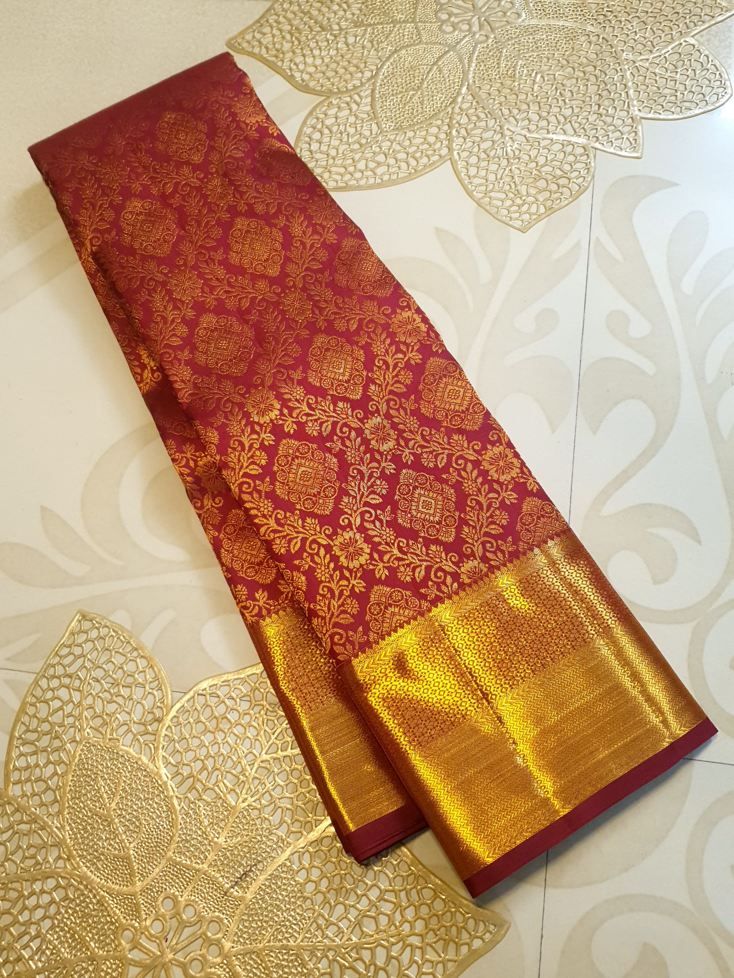 Red Kanchipuram handloom 2G gold pattu silk saree featuring intricate gold brocade weaving and a detailed Lord Murugan pallu.