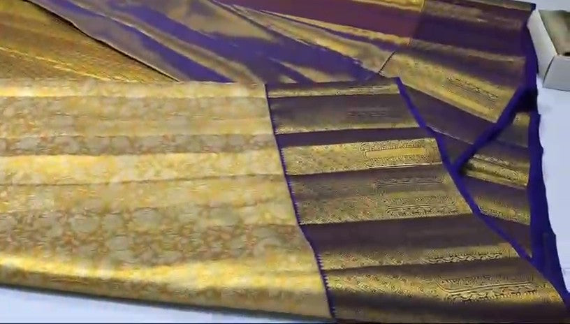 Gold Kanchipuram tissue brocade silk bridal saree with a rich violet border and intricate traditional zari pallu.