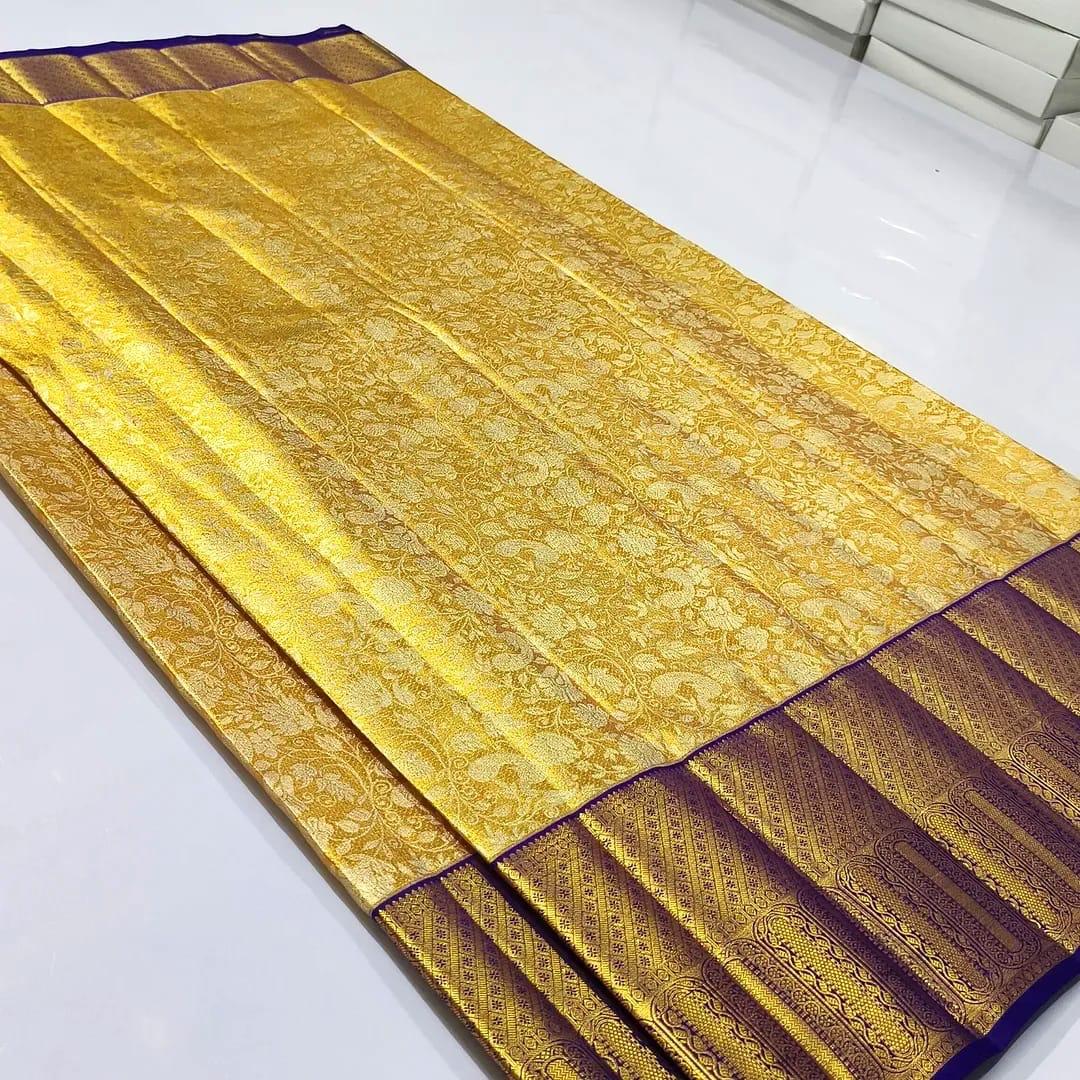 Gold Kanchipuram tissue brocade silk bridal saree with a rich violet border and intricate traditional zari pallu.