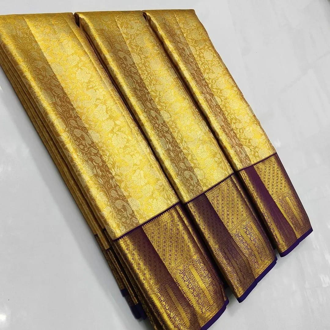 Gold Kanchipuram tissue brocade silk bridal saree with a rich violet border and intricate traditional zari pallu.