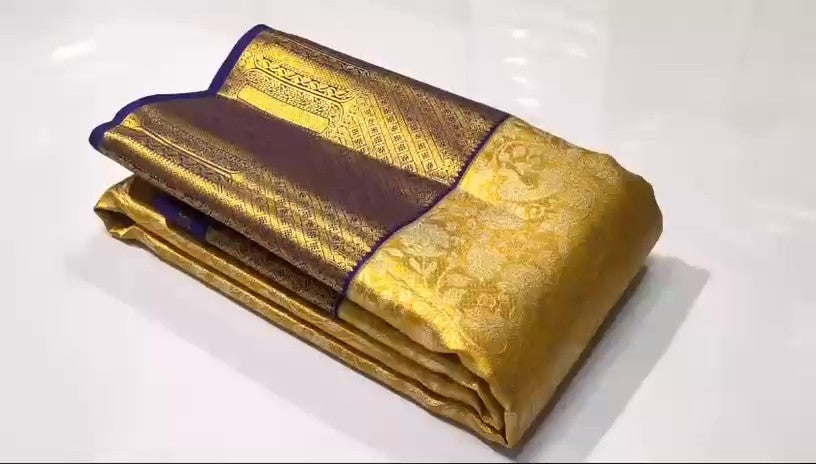Gold Kanchipuram tissue brocade silk bridal saree with a rich violet border and intricate traditional zari pallu.