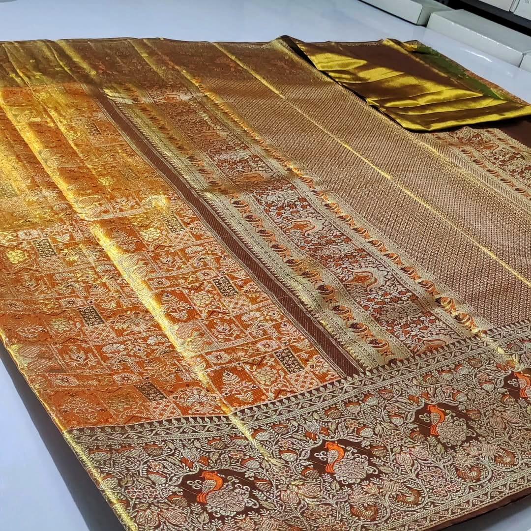 Orange Kanchipuram handloom 1G tissue silk saree with intricate meenakari brocade work and metallic zari borders, styled for a traditional South Indian wedding.